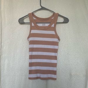 A fitted pink and white tank top